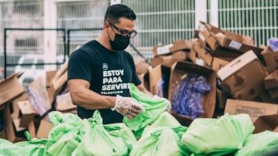 a man in a black shirt and some bags